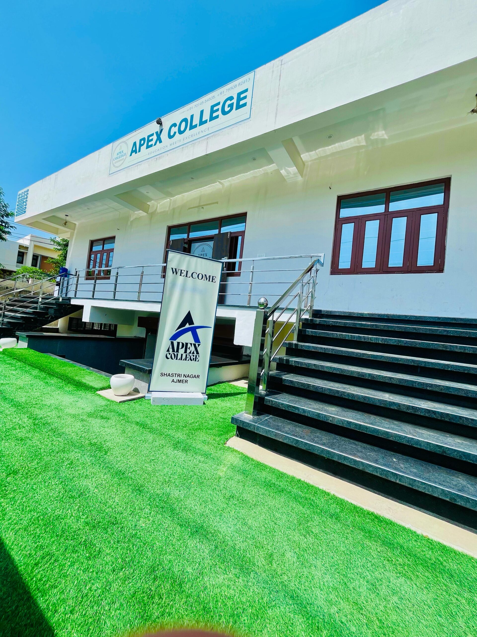 Campus view of Best College in Ajmer - Apex College Ajmer with green lawn.